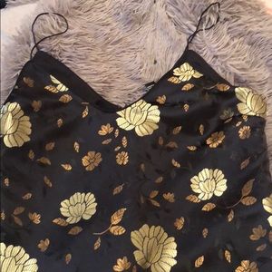 Black dress embroidered with gold flowers.